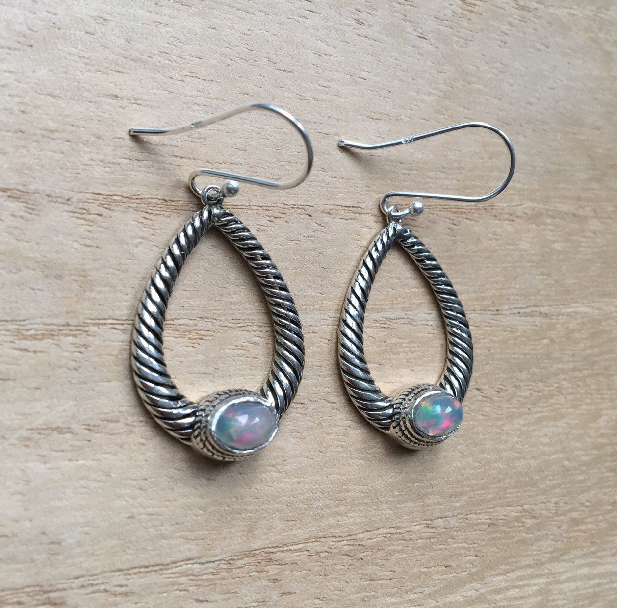 Opal dangly silver earrings Oval